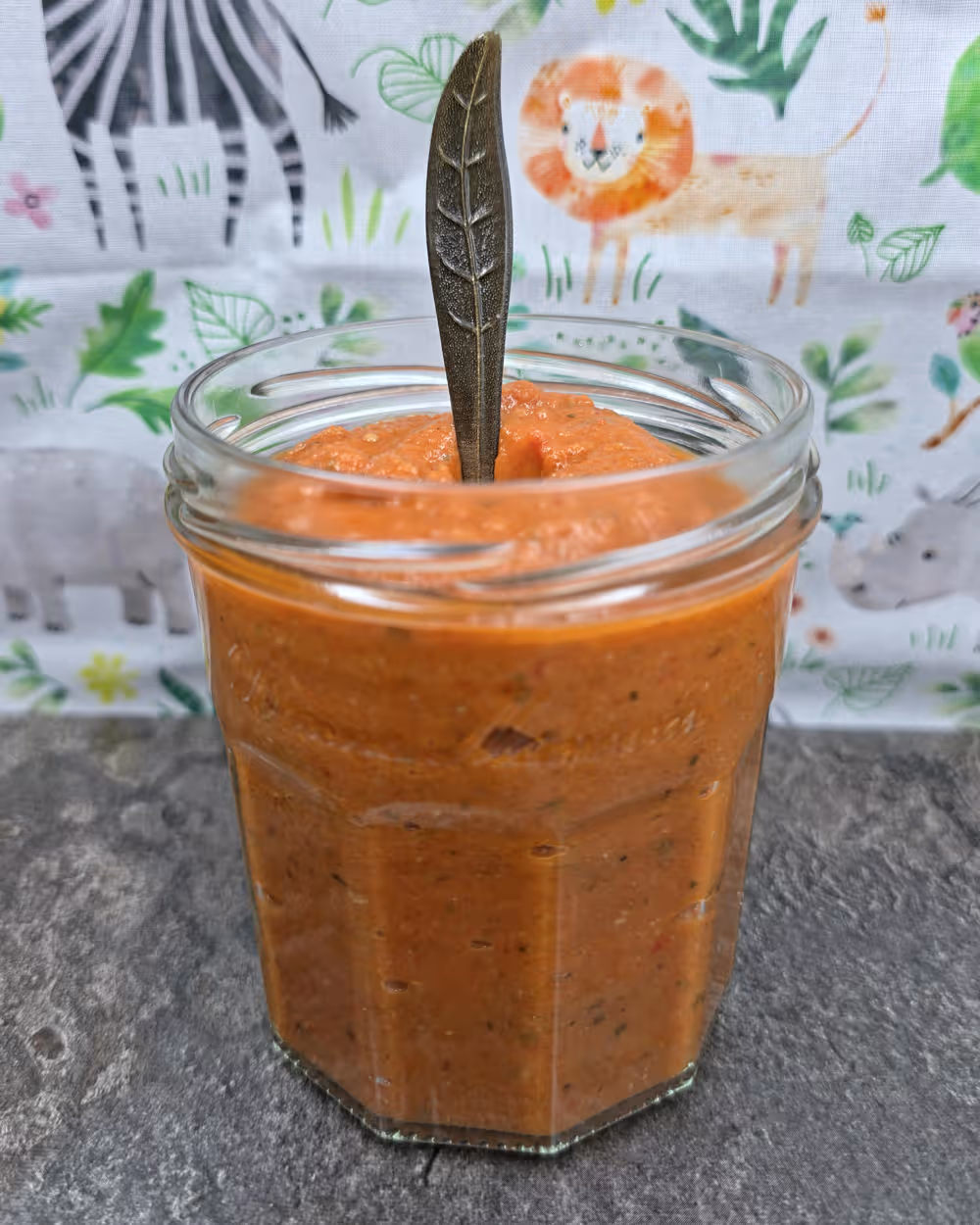 Roasted Vegetable Tomato Sauce, Side view, Glass jar, Leaf shaped spoon