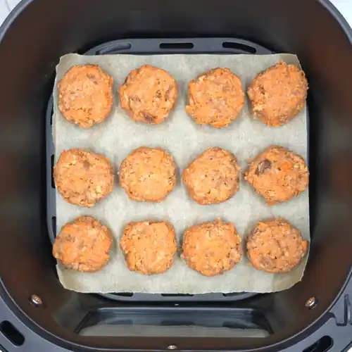  Veggie Nuggets raw on a baking paper lined air fyer basket before baking.  